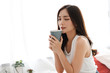 © Art_Photo - Woman drinking coffee in bedroom in the morning