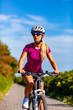 © Jacek Chabraszewski - Young woman cycling