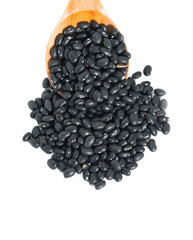 black beans with wooden spoon on white background