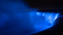 Niagara Falls Illuminated In Glowing Blue Colours