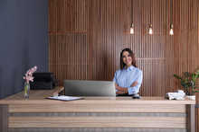 Portrait Of Receptionist At Desk In Lobby