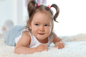 Wall Mural - Adorable little baby girl lying on bed in room