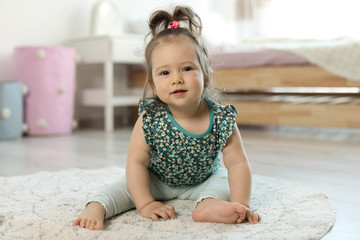 Poster - Adorable little baby girl sitting on floor in room