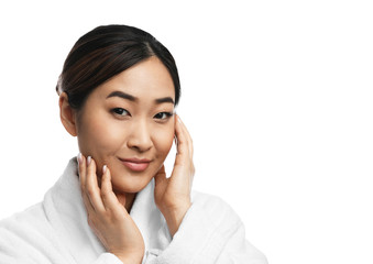 Wall Mural - Portrait of beautiful Asian woman in bathrobe isolated on white. Spa treatment