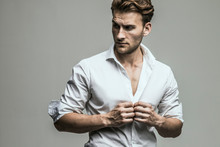 Portrait Of Young And Handsome Model In A White Shirt. Studio Shot. Copy Space.