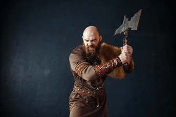 Wall Mural - Angry viking with axe, barbarian image