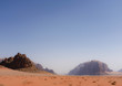 © Winston Springwater - View on sandy valley in Wadi Rum desert, Jordan. Mountain range made from sandstone in the background.