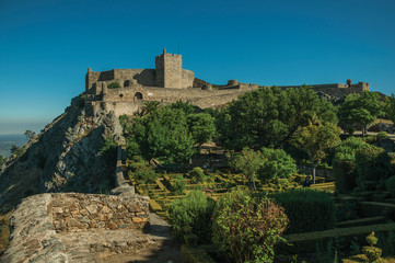 Stone walls and tower of Castle over rocky cliff at Marvao