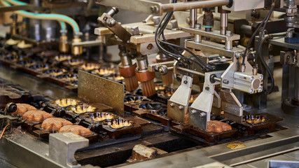 Production belt for baking momiji manju, maple leave biscuits, a traditional pastry on Miyajima island.