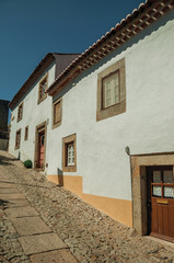 Poster - Old houses with whitewashed wall in an alley of Marvao