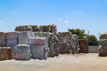 Bangkok/Thailand-June 22,2019: Thai recycle industry cardboard garbage and paper waste after pressing in hydraulic baling garbage press machine to a square dense for transportation to recycle factory