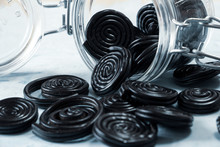 Detail Of Licorice Candy Spirals Outside A Glass Jar