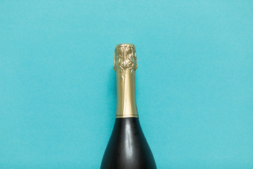 Wall Mural - Party and holiday celebration concept. Champagne bottle on blue background.