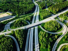 Aerial View Of Highway And Overpass With Green Woods In Finland.