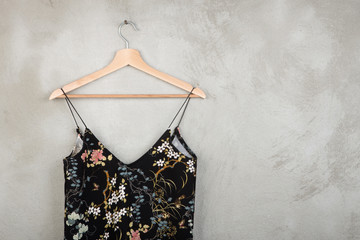 Fashion and shopping concept - beautiful dress in floral pattern on a hanger