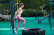 Young woman is training on the outdoor playground. Crossfit and fitness workout outdoors.