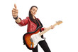 Young girl with a guitar showing thumbs up