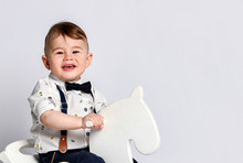 Funny Baby Sitting On The Toy Horse