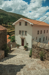 Wall Mural - House at the end of deserted alley on slope with steps