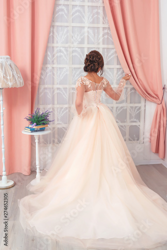 Girl In A Beige Wedding Gown On A Pink Backdrop Curtains Wedding