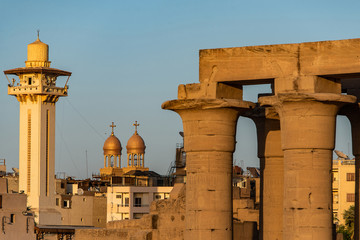 Wall Mural - catholic Church and Muslim Mosque Tower religion Symbols together in Luxor temple at sunset