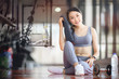 © NAMPIX - Woman exercise workout in gym fitness breaking relax holding towel, smiling and looking at camera