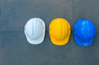 © Pornnarong - Helmet hat for safety work on concrete floor .Top view