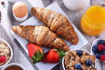 Breakfast served with coffee, juice, croissants and fruits