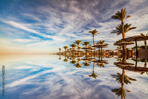 beautiful-romantic-sunset-over-a-sandy-beach-and-palm-trees-egypt-hurghada