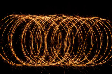 Poster - Sparkle golden glowing shiny spiral lines and circle light effect. Abstract Glowing light fire ring trace.