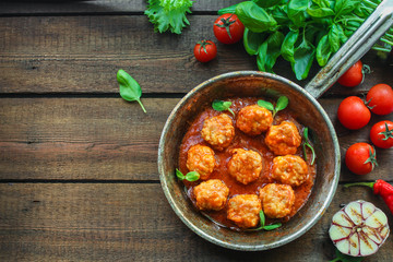 meatballs in tomato sauce and basil (meat dish). food background. top view. copy space