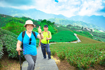 Sticker - happy asian senior couple hiking in the nature