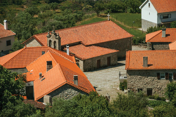 Wall Mural - Hilly landscape with the roofs from village