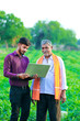 © PRASANNAPIX - indian agronomist with farmer at field