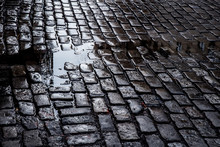View Of Grungy Cobblestone Street With Puddles, New York City