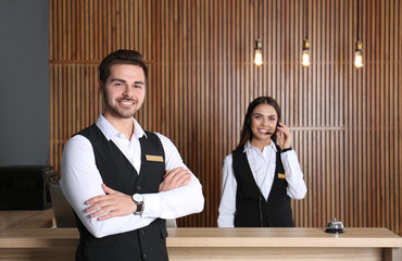 Canvas Print - Receptionist at desk with colleague in lobby