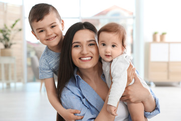 Canvas Print - Happy mother with her cute children at home. Family time