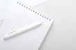 © mellisandra - White open notebook with pen on gray and white background. Concept office desk, business. Top view, flat lay.