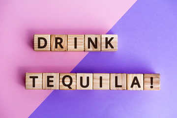 Fototapete - phrase drink tequila, wooden cubes with letters on color background top view