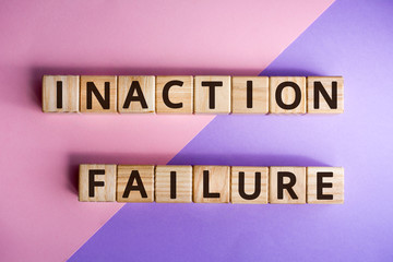 Fototapete - phrase inaction failure, wooden cubes with letters on color background top view