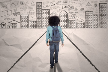 Wall Mural - Male college student walks on a crumpled paper