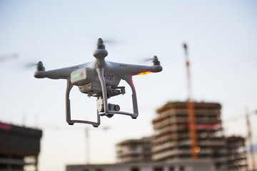 Wall Mural - drone quadcopter with digital camera in city