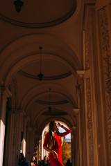 Profile of a girl in a red dress and a hand in her hair. beautif