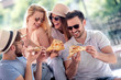 © ivanko80 - Cheerful friends eat pizza together