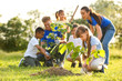 © New Africa - Kids planting trees with volunteers in park