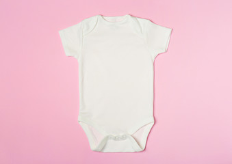 Cute baby onesie on color background, top view