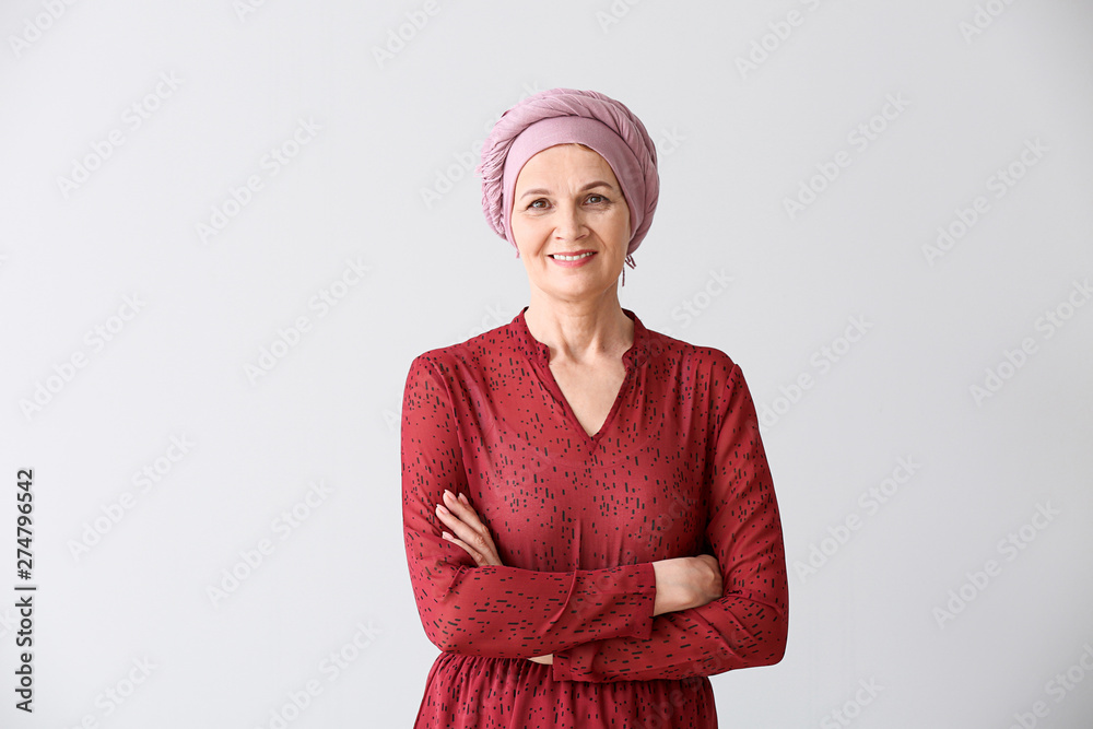 Mature woman after chemotherapy on light background