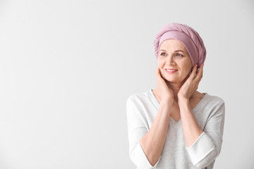 Wall Mural - Mature woman after chemotherapy on light background