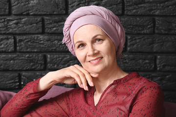 Sticker - Mature woman after chemotherapy on dark brick background