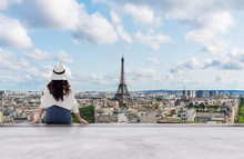 Young Traveler Woman In White Hat Looking At Eiffel Tower, Famous Landmark And Travel Destination In Paris, France In Summer